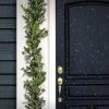 National Tree Company HGTV Home Collection 9ft Pre-Lit Winter Garden Artificial Garland with Pinecones and Fern Fronds, Green