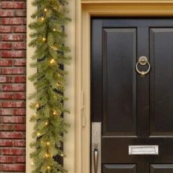 National Tree Company Pre-Lit Artificial Christmas Garland, Green, Downswept Douglas Fir, White Lights, Plug In, Christmas Collection, 9 Feet