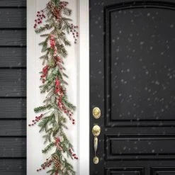 HGTV Home Collection 9ft Pre Lit Artificial Christmas Garland, Snow-dusted Branch Tips, Decorated with Pinecones, Berries, and Bow